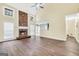 Living room featuring a stone fireplace, hardwood floors, and an open view to the kitchen at 70 Barrington Farms Ct, Sharpsburg, GA 30277