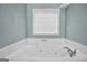 Main bathroom features an oversized soaking tub with jets and tile surround at 70 Barrington Farms Ct, Sharpsburg, GA 30277