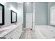 Bright main bathroom features double sinks, tile flooring, and a soaking tub at 70 Barrington Farms Ct, Sharpsburg, GA 30277