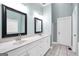 Bright main bathroom features double sinks, tile flooring, and updated fixtures at 70 Barrington Farms Ct, Sharpsburg, GA 30277