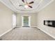 Main bedroom features neutral walls, trey ceiling, access to deck, and a fireplace at 70 Barrington Farms Ct, Sharpsburg, GA 30277