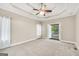 Main bedroom with neutral walls, large windows, and trey ceiling at 70 Barrington Farms Ct, Sharpsburg, GA 30277