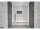 Modern walk-in shower boasts stunning tile work and a built-in bench for added convenience at 70 Barrington Farms Ct, Sharpsburg, GA 30277