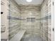 Walk-in shower with glass enclosure, bench and decorative tile details at 70 Barrington Farms Ct, Sharpsburg, GA 30277