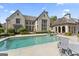 Stunning backyard with a large swimming pool, patio area, and beautifully landscaped grounds at 140 Newhaven Dr, Fayetteville, GA 30215