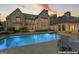 Gorgeous backyard featuring a sparkling pool, spa, and a covered outdoor living space at 140 Newhaven Dr, Fayetteville, GA 30215