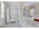 Bright bathroom featuring a combination shower and tub, decorative tiles, and ample cabinet space at 140 Newhaven Dr, Fayetteville, GA 30215