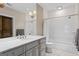 Bathroom features a subway tile shower, a marble countertop vanity, and patterned tile floor at 140 Newhaven Dr, Fayetteville, GA 30215