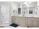 Bright bathroom with double vanity, shower, and modern fixtures at 140 Newhaven Dr, Fayetteville, GA 30215