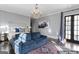 Staged bedroom features large windows, a comfortable seating area, and a plush bed with patterned pillows at 140 Newhaven Dr, Fayetteville, GA 30215