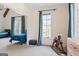 This ' bedroom features a rocking horse, a window view, and beige patterned wallpaper at 140 Newhaven Dr, Fayetteville, GA 30215