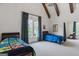 This bedroom features a beamed ceiling, a window with a view, and two twin beds at 140 Newhaven Dr, Fayetteville, GA 30215