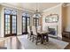 Elegant dining room with french doors, decorative mirror, fireplace, and seating for six at 140 Newhaven Dr, Fayetteville, GA 30215