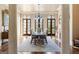 Formal dining room with wooden floors, a fireplace, and multiple french doors to the outdoors at 140 Newhaven Dr, Fayetteville, GA 30215
