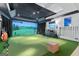 Home entertainment room featuring a golf simulator, large screen, and golf accessories at 140 Newhaven Dr, Fayetteville, GA 30215