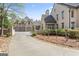 Elegant home featuring a long driveway leading to a three-car garage and beautifully landscaped grounds at 140 Newhaven Dr, Fayetteville, GA 30215