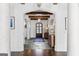 Open concept foyer with stone floors, timber ceiling beams, and elegant lighting fixtures at 140 Newhaven Dr, Fayetteville, GA 30215