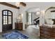 Inviting foyer with hardwood floors, elegant lighting, and a view of the home's grand piano at 140 Newhaven Dr, Fayetteville, GA 30215
