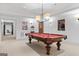 Inviting game room with a classic pool table, movie posters, and ample lighting at 140 Newhaven Dr, Fayetteville, GA 30215