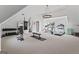 Spacious home gym with vaulted ceilings, featuring ample workout equipment and natural light at 140 Newhaven Dr, Fayetteville, GA 30215