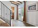 Hallway features staircase, stone floors, decorative sconces, and a large window at 140 Newhaven Dr, Fayetteville, GA 30215