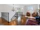 Bright hallway featuring hardwood floors, ornate lighting, and seating area with two chairs at 140 Newhaven Dr, Fayetteville, GA 30215