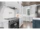 Kitchen with a large stove, stainless steel appliances, custom cabinets, subway tile backsplash, and eat-in area at 140 Newhaven Dr, Fayetteville, GA 30215