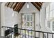Two-story living room features a large window, marble accents, and cathedral ceilings with wood beams at 140 Newhaven Dr, Fayetteville, GA 30215