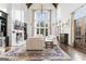 Spacious living room boasts high ceilings, large windows, and a fireplace with custom built-ins at 140 Newhaven Dr, Fayetteville, GA 30215