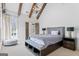 This main bedroom features a large window, exposed beams, and a chandelier at 140 Newhaven Dr, Fayetteville, GA 30215