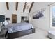 This main bedroom features exposed beams, a chandelier, and an interesting painting of a moose at 140 Newhaven Dr, Fayetteville, GA 30215