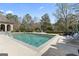 Inviting backyard pool with lounge chairs, dining area, and beautiful landscaping for ultimate relaxation at 140 Newhaven Dr, Fayetteville, GA 30215