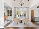 Sun-drenched sitting area featuring cathedral ceiling, large windows, and custom built-in shelves at 140 Newhaven Dr, Fayetteville, GA 30215