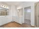 Bathroom featuring double vanity with white cabinets and a walk-in closet at 315 Arwen Dr # 105, Mcdonough, GA 30252