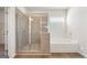 Bathroom showing tiled walk-in shower and a luxurious soaking tub next to a window at 315 Arwen Dr # 105, Mcdonough, GA 30252