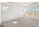 Spacious bedroom with neutral carpet, tray ceiling, and sun-filled windows at 315 Arwen Dr # 105, Mcdonough, GA 30252
