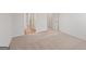 This bedroom features neutral carpet, white walls and doors, and a view into the hallway at 315 Arwen Dr # 105, Mcdonough, GA 30252