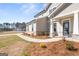 Close-up of a home's entrance featuring a covered porch with white columns and stone accents at 315 Arwen Dr # 105, Mcdonough, GA 30252