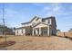 Charming two-story home with neutral siding, a covered porch, and a neatly kept lawn on a sunny day at 315 Arwen Dr # 105, Mcdonough, GA 30252