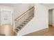 Elegant foyer with hardwood floors, a wooden staircase, and a view of the front door at 315 Arwen Dr # 105, Mcdonough, GA 30252