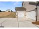 Spacious three-car garage with white doors and stone detailing, complemented by a concrete driveway at 315 Arwen Dr # 105, Mcdonough, GA 30252