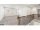 Hallway with neutral carpet, window, and railing with stairs visible at 315 Arwen Dr # 105, Mcdonough, GA 30252