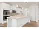 Gourmet kitchen featuring stainless steel appliances, white cabinets, and a large center island at 315 Arwen Dr # 105, Mcdonough, GA 30252