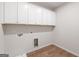 Laundry room featuring wood-look floors, a sink, and white cabinets for storage at 315 Arwen Dr # 105, Mcdonough, GA 30252