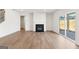 Spacious living room with a fireplace, hardwood floors, and a sliding glass door to the outside at 315 Arwen Dr # 105, Mcdonough, GA 30252