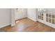 Bright living room showcasing wood floors, large windows, and French doors, creating an inviting space at 315 Arwen Dr # 105, Mcdonough, GA 30252