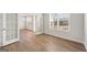 Bright, airy living room with wood floors, large windows, and French doors opening to another room at 315 Arwen Dr # 105, Mcdonough, GA 30252