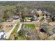 An aerial view of the property surrounded by lush trees and multiple homes in a peaceful neighborhood at 108 White Oak Tl, Cumming, GA 30028