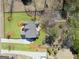 Aerial view of a meticulously landscaped backyard, featuring a large deck off the rear of the home at 108 White Oak Tl, Cumming, GA 30028