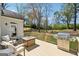 Relaxing back deck with modern grill, outdoor seating, and fire pit with a view of the wooded backyard at 108 White Oak Tl, Cumming, GA 30028